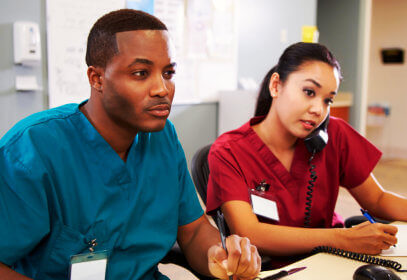 two healthcare workers working