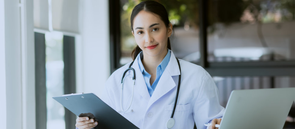 healthcare worker holding a clipboard while working